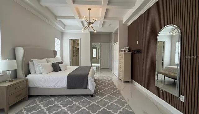 a spacious bedroom with a bed and wooden floor