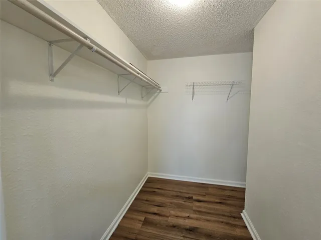 a view of hallway with wooden floor
