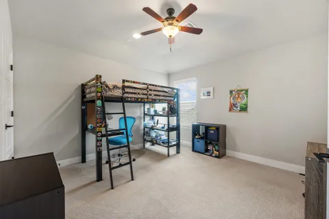 a living room with furniture and a book shelf