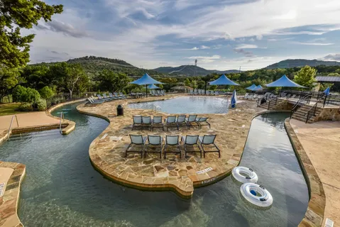 a view of yard with swimming pool and sitting area