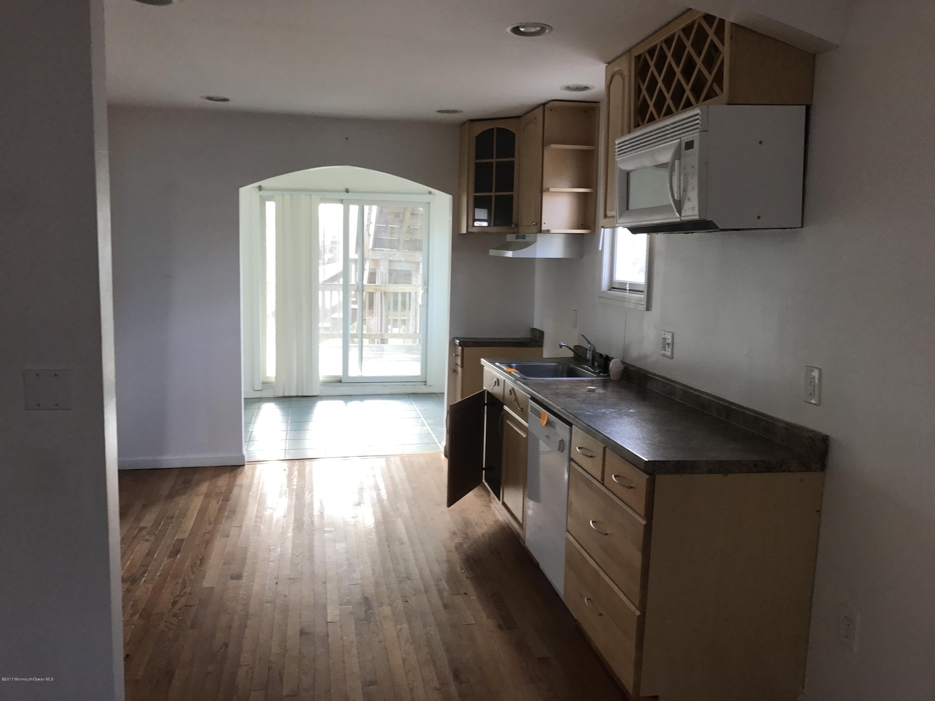 155 County Road Cliffwood, NJ 07721 - Photo 3 of 17 a kitchen with a sink and wooden floor