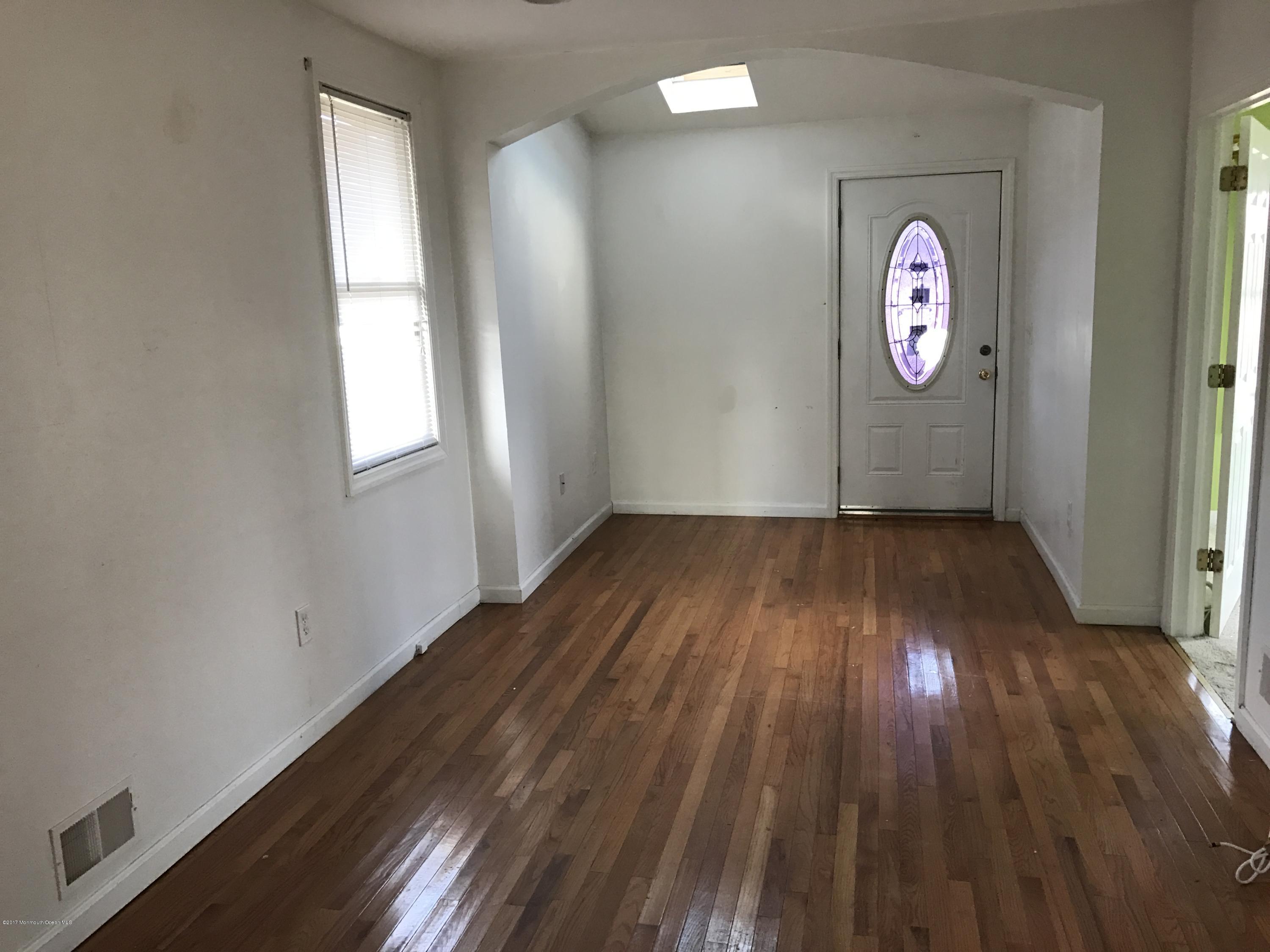 155 County Road Cliffwood, NJ 07721 - Photo 5 of 17 an empty room with wooden floor and windows