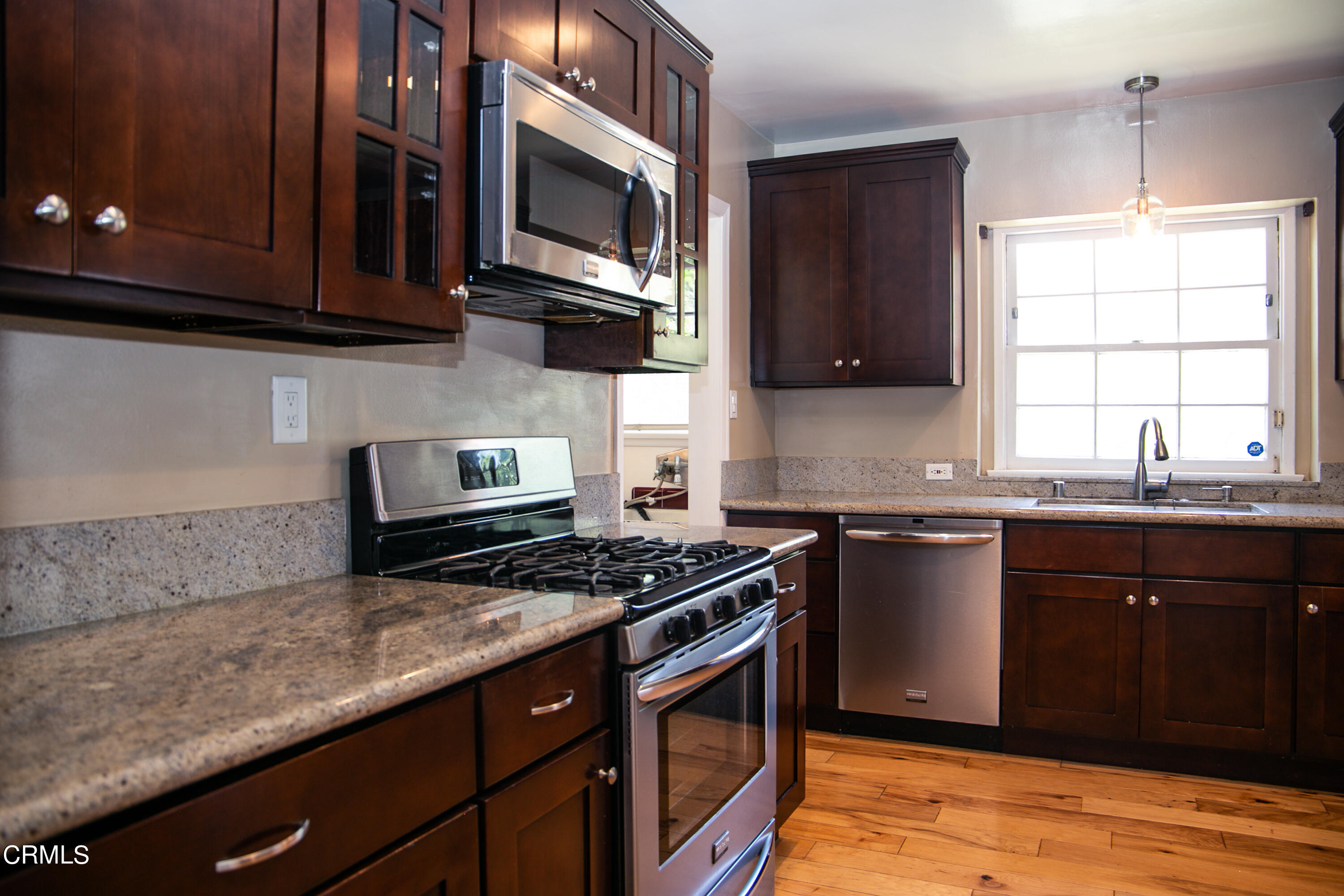 7601 Flight Avenue Los Angeles, CA 90045 - Photo 11 of 36 a kitchen with stainless steel appliances granite countertop a stove a microwave a sink and cabinets
