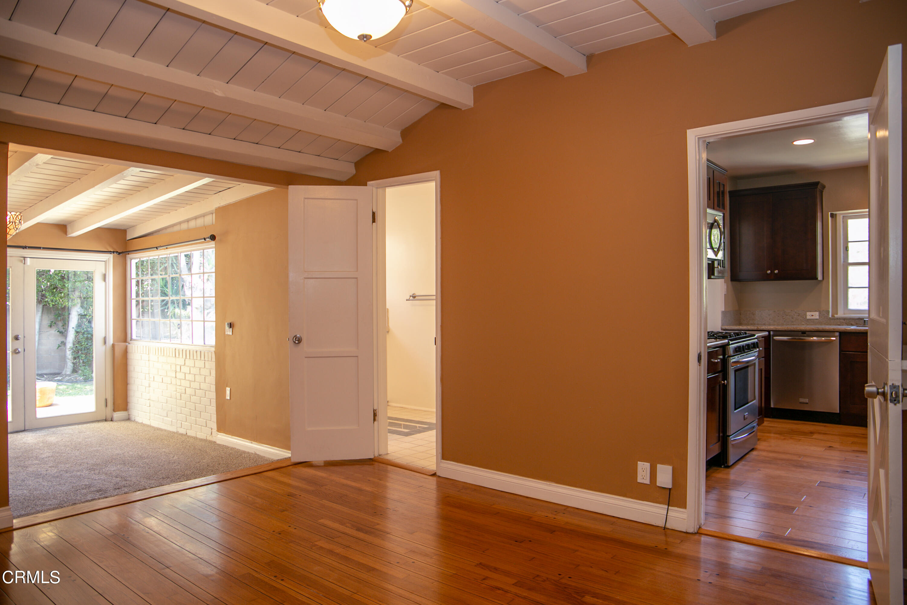7601 Flight Avenue Los Angeles, CA 90045 - Photo 14 of 36 a view of a hallway with wooden floor and a kitchen
