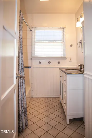 a room with a window a sink and a mirror