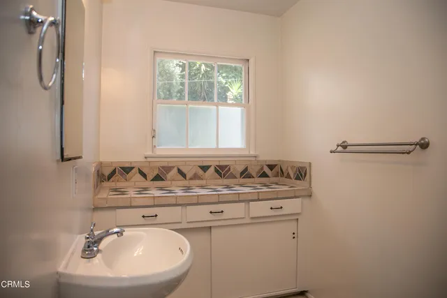 a bathroom with a sink toilet and mirror