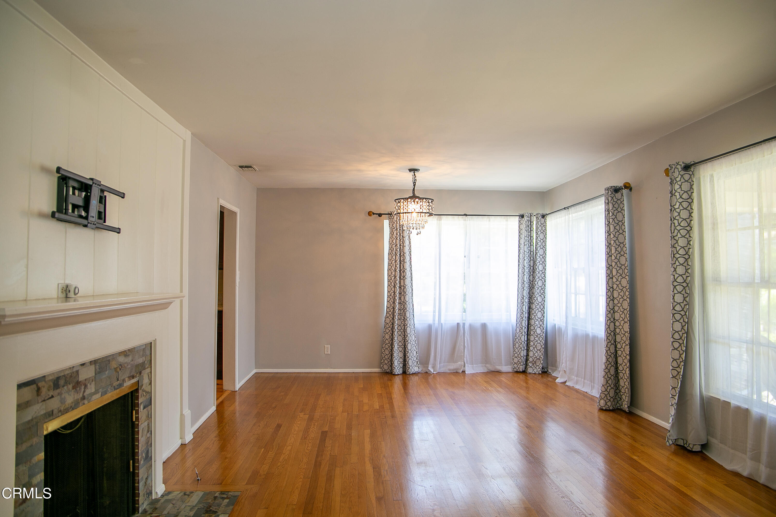 7601 Flight Avenue Los Angeles, CA 90045 - Photo 3 of 36 an empty room with wooden floor fireplace and windows