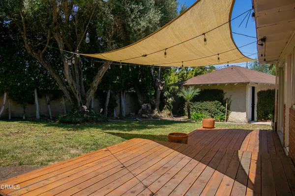 a view of a house with backyard porch and sitting area
