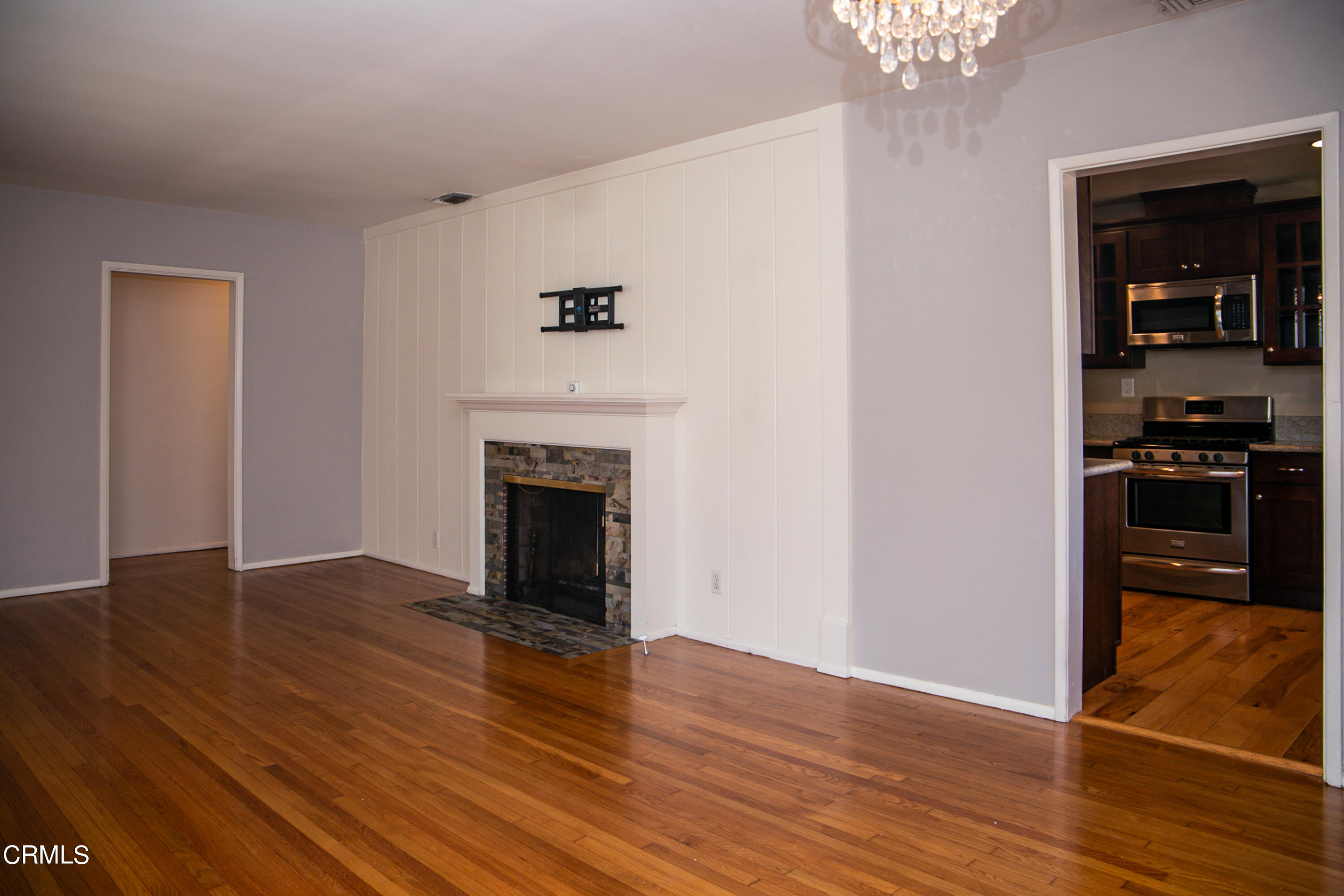 7601 Flight Avenue Los Angeles, CA 90045 - Photo 4 of 36 a view of a livingroom with wooden floor and a kitchen