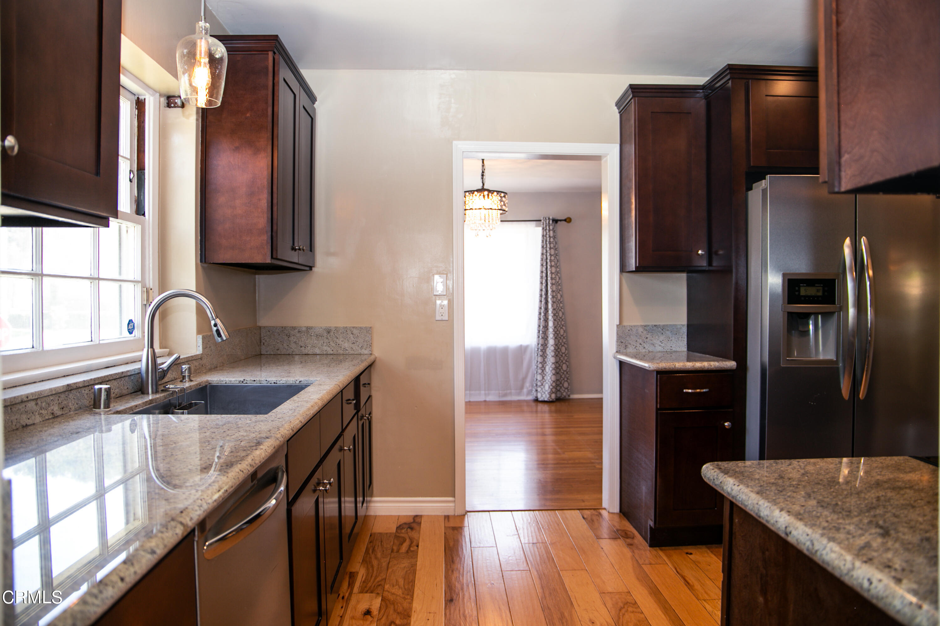 7601 Flight Avenue Los Angeles, CA 90045 - Photo 8 of 36 a kitchen with granite countertop a refrigerator a sink a stove and cabinets