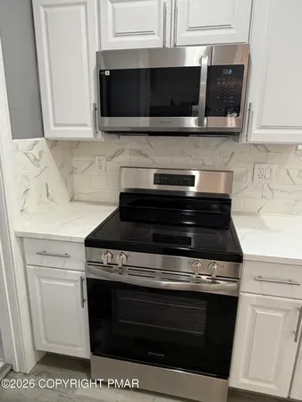 a stove top oven sitting inside of a kitchen