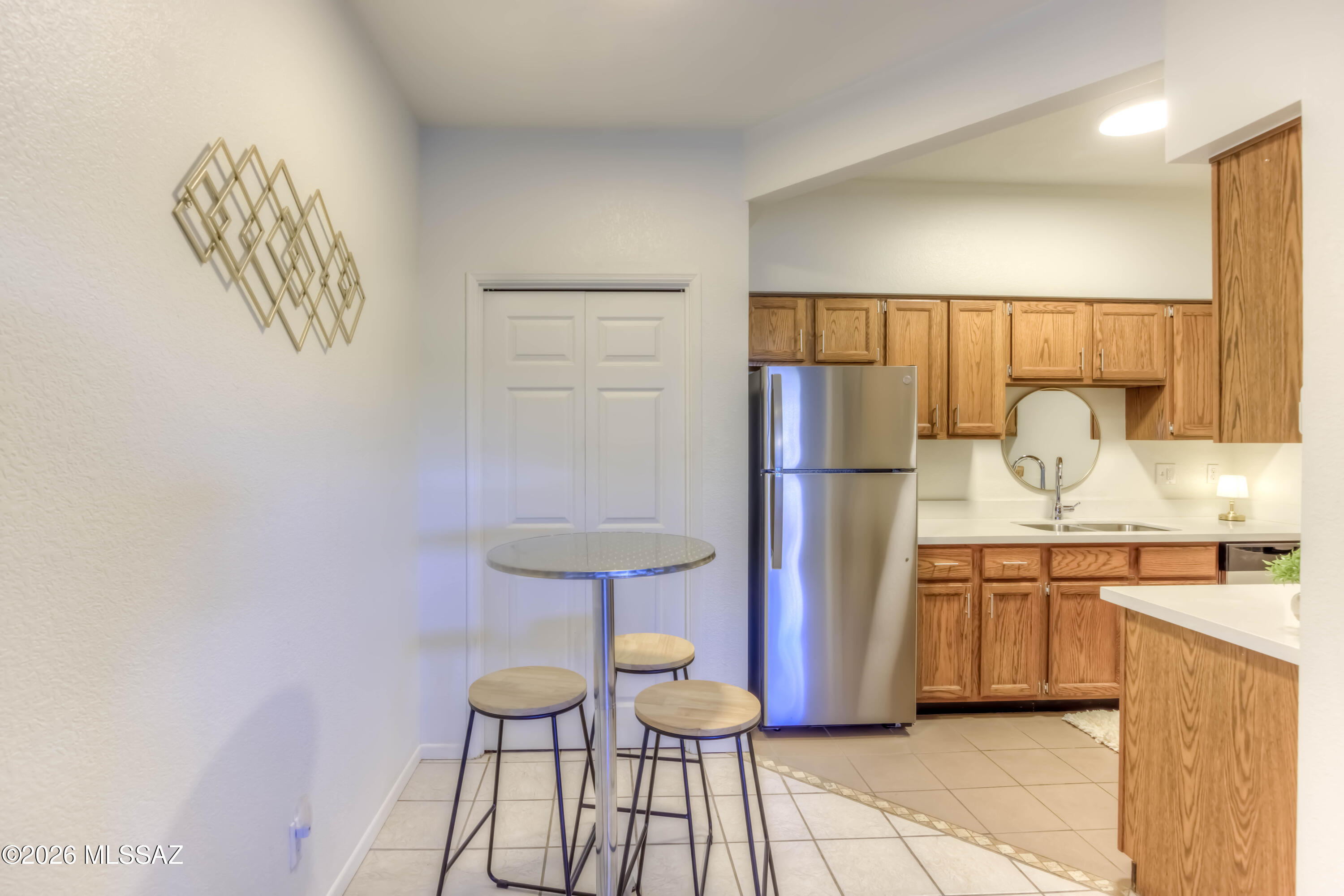 5500 North Valley View Road, Unit 123 Tucson, AZ 85718 - Photo 14 of 36 a kitchen with stainless steel appliances granite countertop a refrigerator and a sink