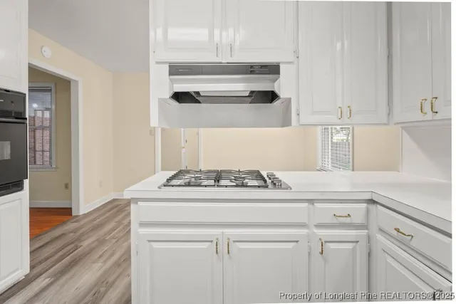 a kitchen with a stove and a refrigerator