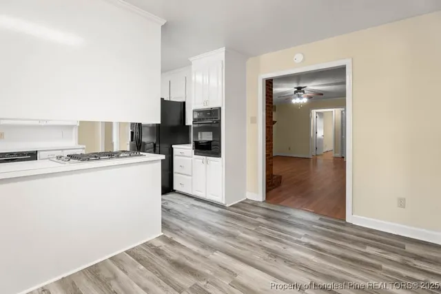 a view of kitchen with cabinets and wooden floor