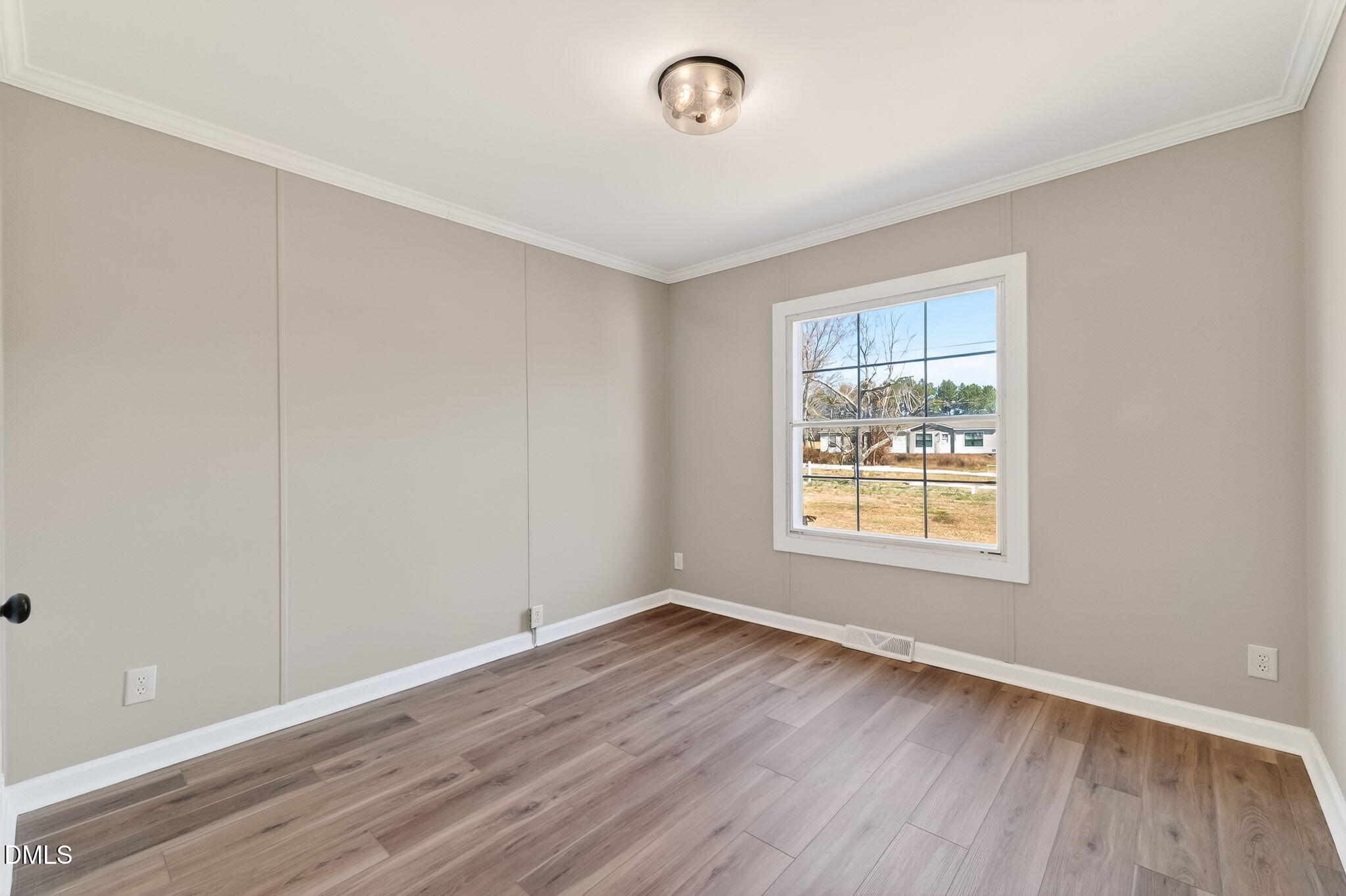 10015 Smith Road Middlesex, NC 27557 - Photo 36 of 48 an empty room with wooden floor and windows