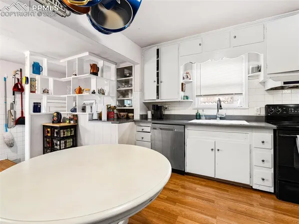 a kitchen with stainless steel appliances kitchen island granite countertop a sink and cabinets