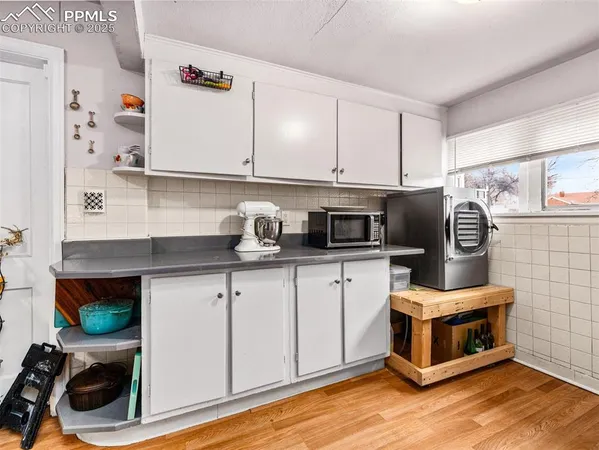 a kitchen with stainless steel appliances a stove a microwave a refrigerator and cabinets