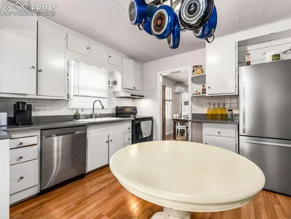 a kitchen with stainless steel appliances a refrigerator sink and cabinets