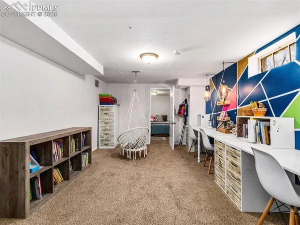 a living room with furniture and a book shelf