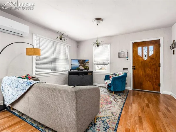 a living room with furniture and wooden floor