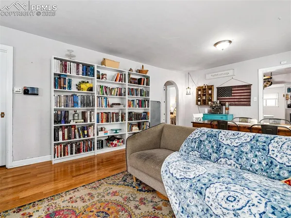a living room with furniture and a book shelf
