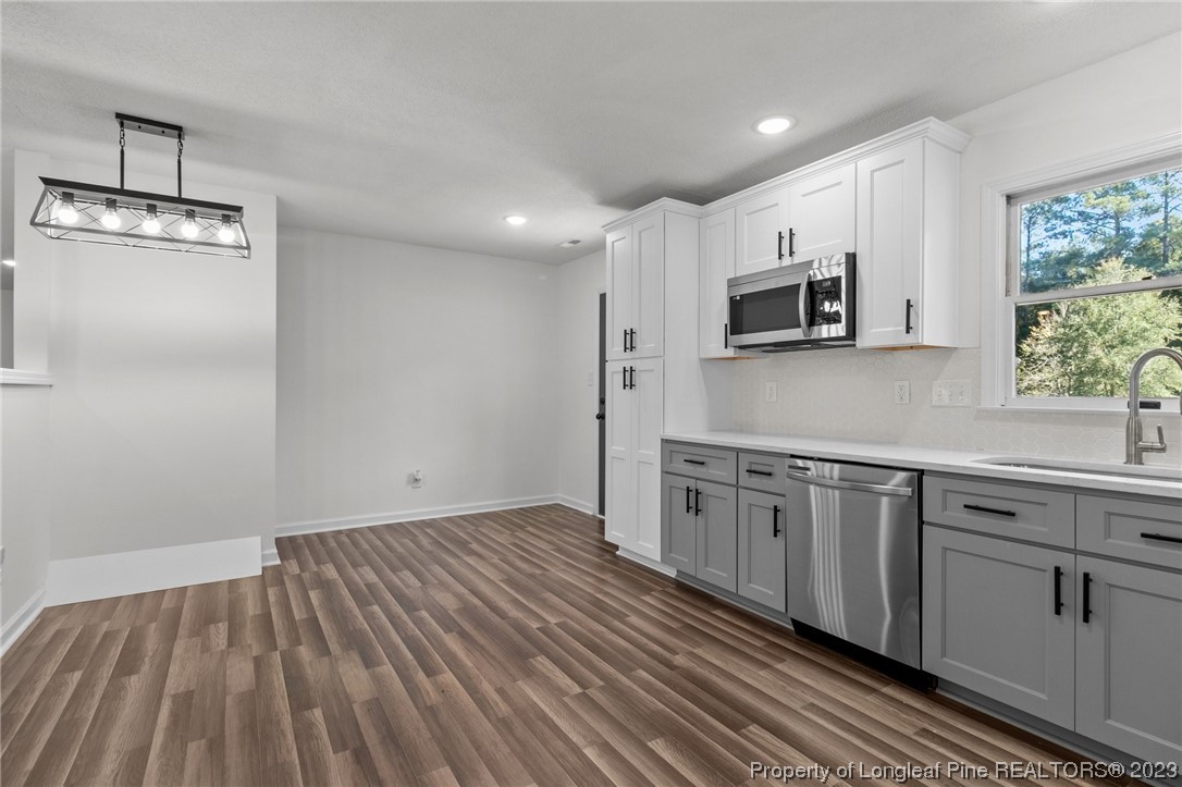 4659 Tabor Church Road Fayetteville, NC 28312 - Photo 12 of 50 a kitchen with stainless steel appliances granite countertop a stove a sink and a microwave