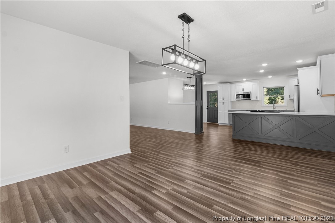 4659 Tabor Church Road Fayetteville, NC 28312 - Photo 14 of 50 a view of a kitchen with a sink and wooden floor