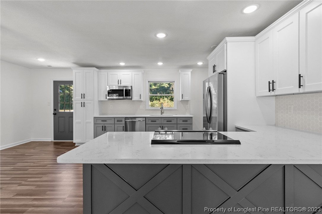 4659 Tabor Church Road Fayetteville, NC 28312 - Photo 15 of 50 a kitchen with kitchen island stainless steel appliances a sink and a refrigerator