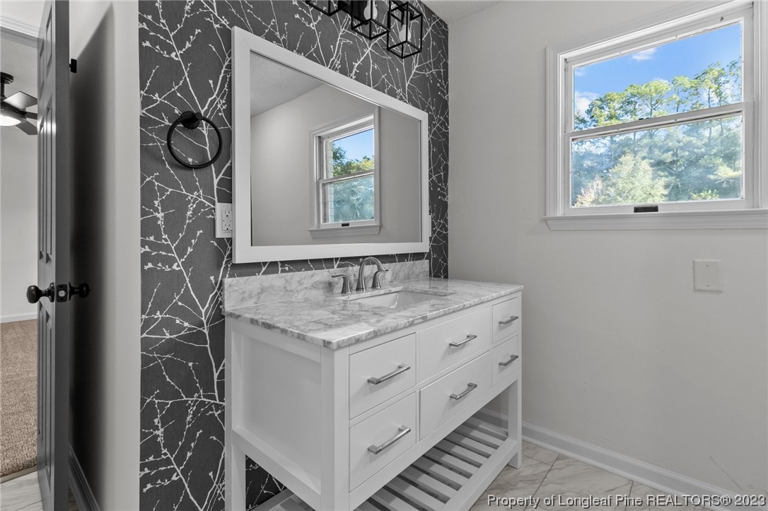 4659 Tabor Church Road Fayetteville, NC 28312 - Photo 16 of 50 a bathroom with a granite countertop sink and a mirror