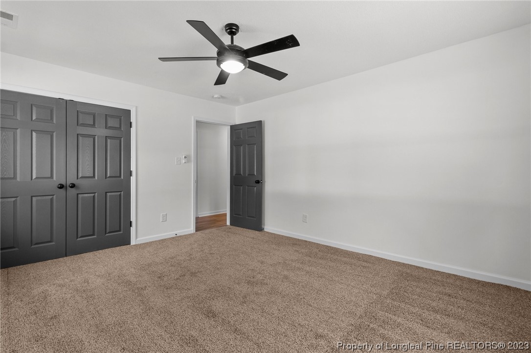 4659 Tabor Church Road Fayetteville, NC 28312 - Photo 17 of 50 an empty room with a ceiling fan and a window