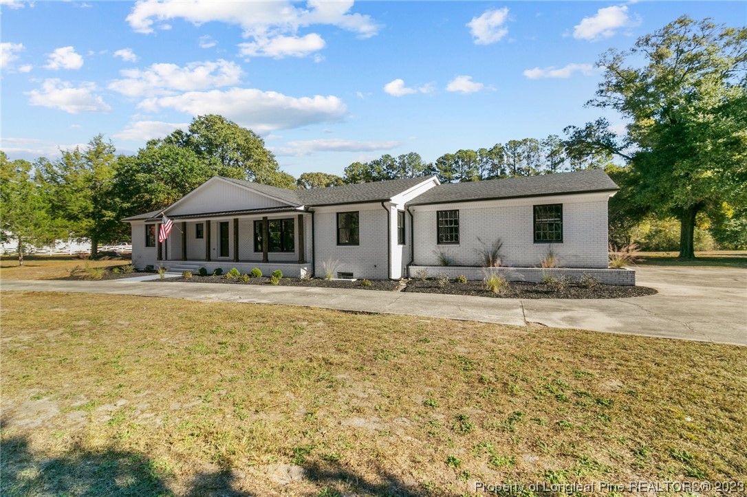 4659 Tabor Church Road Fayetteville, NC 28312 - Photo 2 of 50 a swimming pool view with a seating space