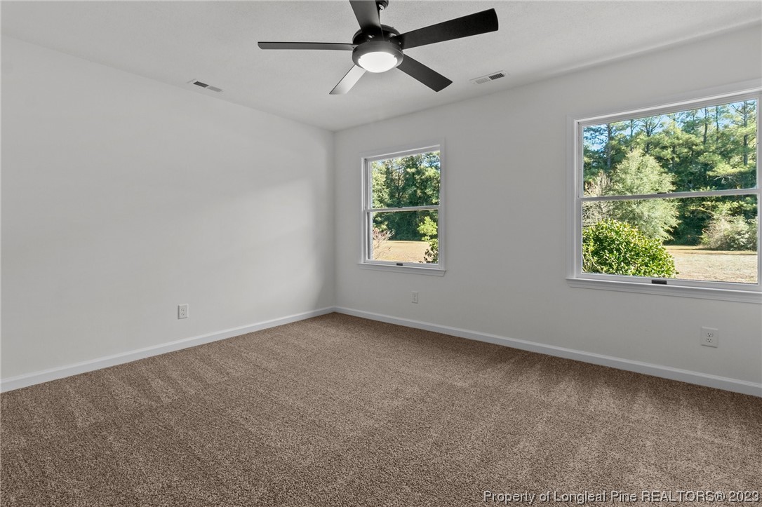 4659 Tabor Church Road Fayetteville, NC 28312 - Photo 21 of 50 an empty room with a window and a ceiling fan