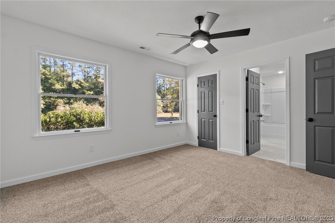 4659 Tabor Church Road Fayetteville, NC 28312 - Photo 24 of 50 a view of a livingroom with a ceiling fan and window