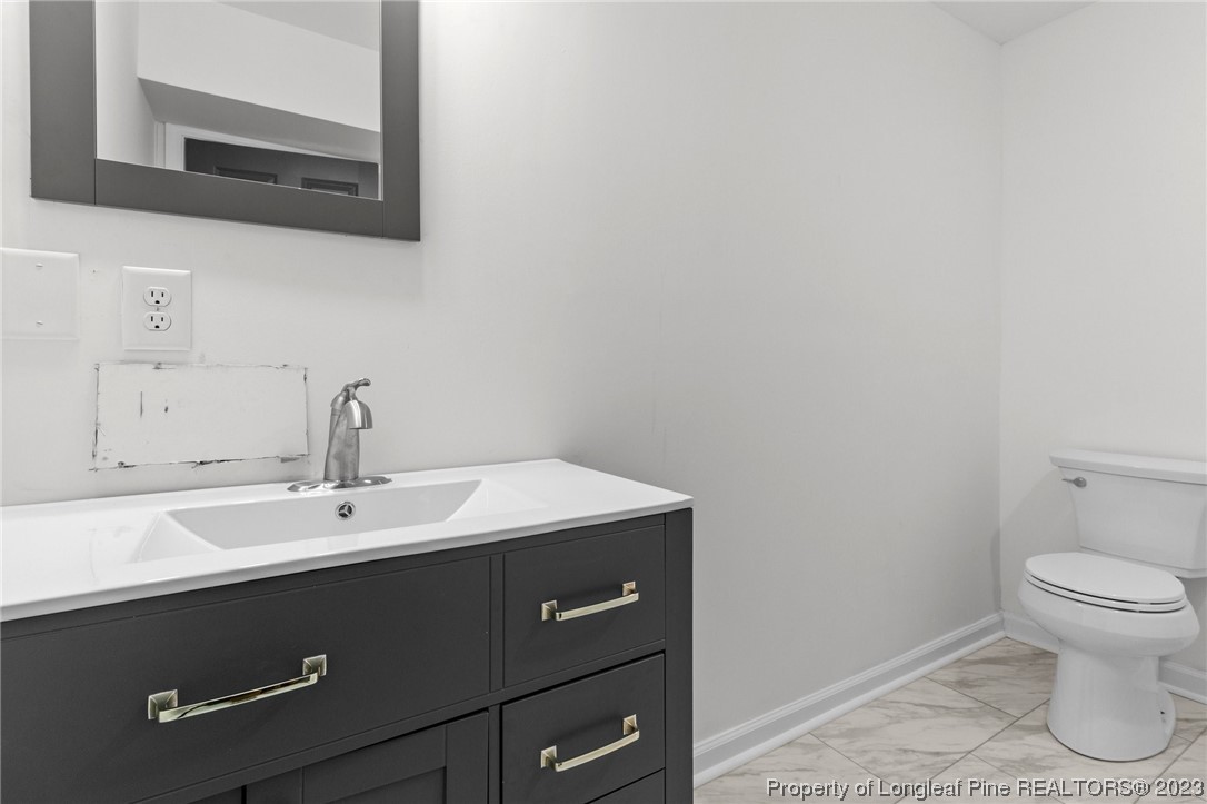 4659 Tabor Church Road Fayetteville, NC 28312 - Photo 25 of 50 a bathroom with a sink and a toilet