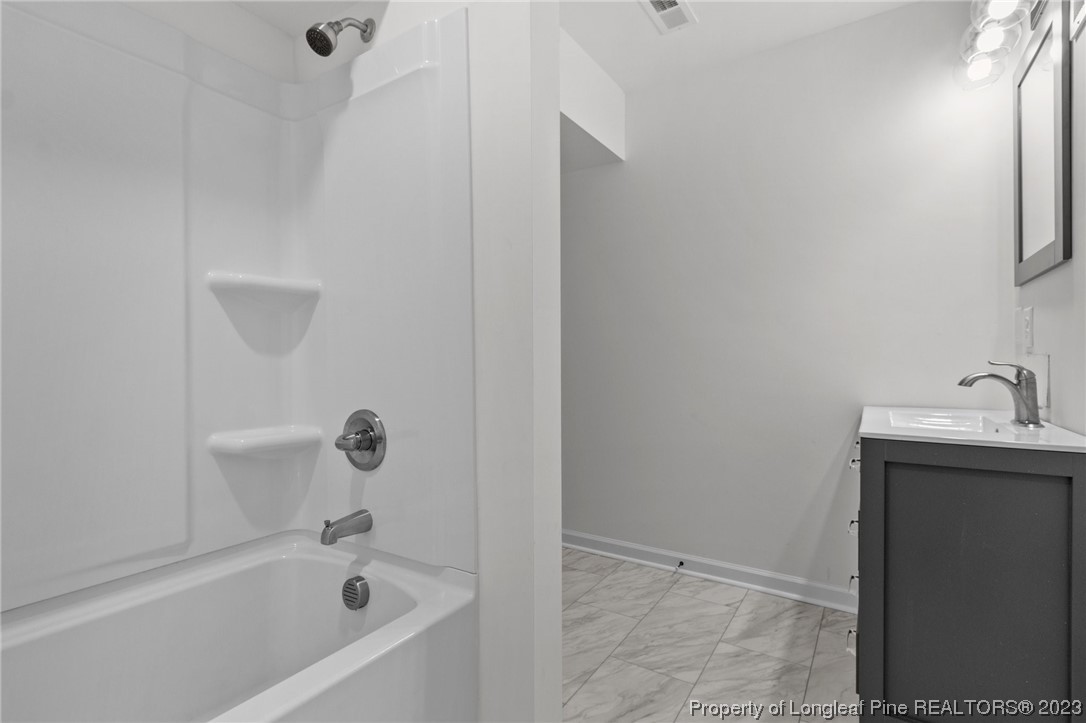 4659 Tabor Church Road Fayetteville, NC 28312 - Photo 32 of 50 a white bath tub sitting next to a white sink