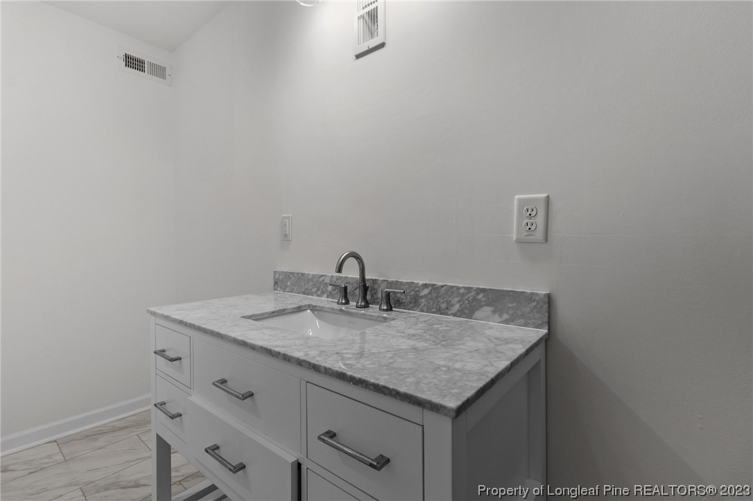 4659 Tabor Church Road Fayetteville, NC 28312 - Photo 35 of 50 a bathroom with a granite countertop sink and vanity