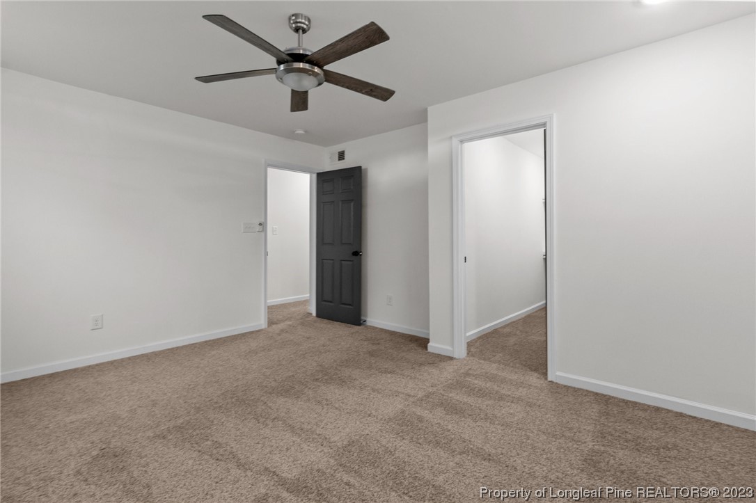 4659 Tabor Church Road Fayetteville, NC 28312 - Photo 37 of 50 an empty room with closet and a ceiling fan