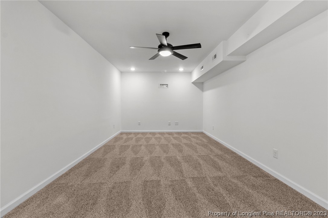 4659 Tabor Church Road Fayetteville, NC 28312 - Photo 39 of 50 en empty room with ceiling fan and window