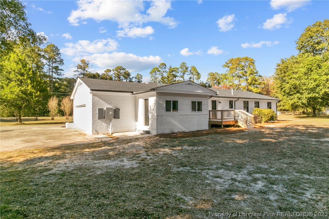 4659 Tabor Church Road Fayetteville, NC 28312 - Photo 43 of 50 a view of a white house with a big yard and large trees