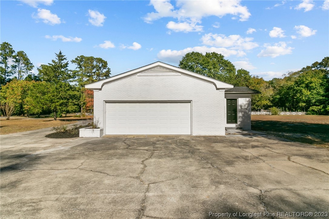 4659 Tabor Church Road Fayetteville, NC 28312 - Photo 44 of 50 a view of a house with a yard and garage