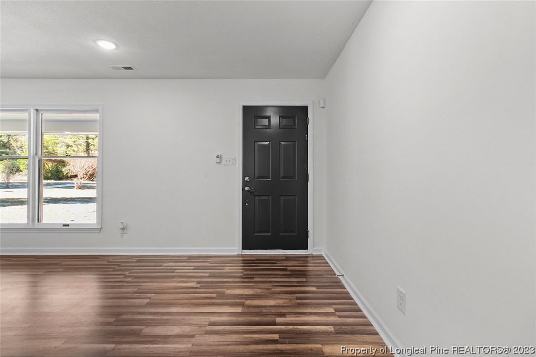 4659 Tabor Church Road Fayetteville, NC 28312 - Photo 5 of 50 an empty room with wooden floor and windows