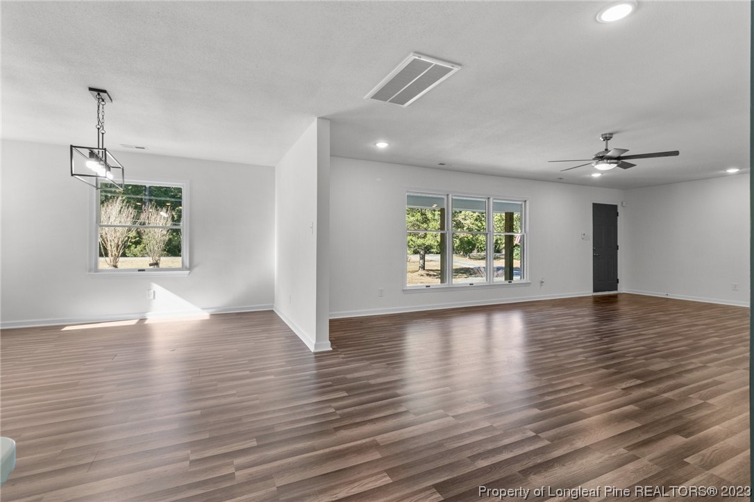 4659 Tabor Church Road Fayetteville, NC 28312 - Photo 6 of 50 a view of an empty room with window and wooden floor