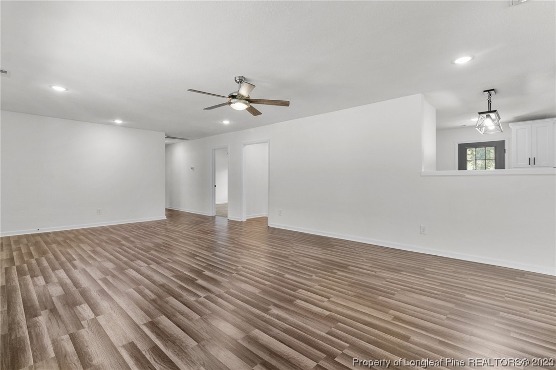 4659 Tabor Church Road Fayetteville, NC 28312 - Photo 7 of 50 a view of an empty room with wooden floor and a ceiling fan