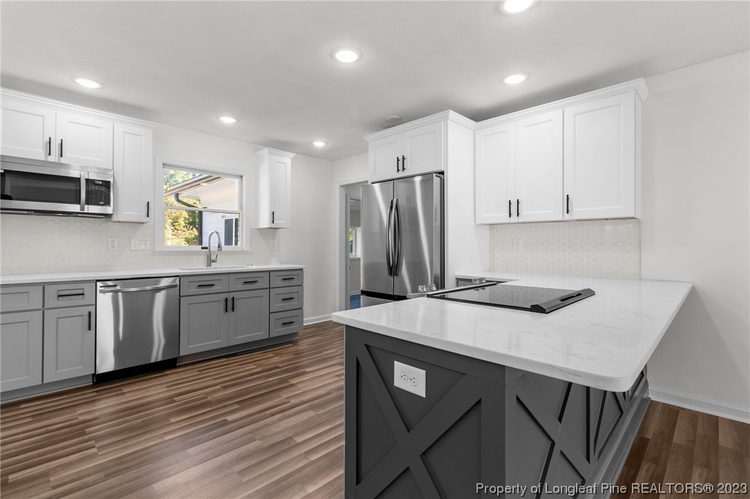 4659 Tabor Church Road Fayetteville, NC 28312 - Photo 9 of 50 a kitchen with stainless steel appliances a stove a sink a microwave a refrigerator and cabinets