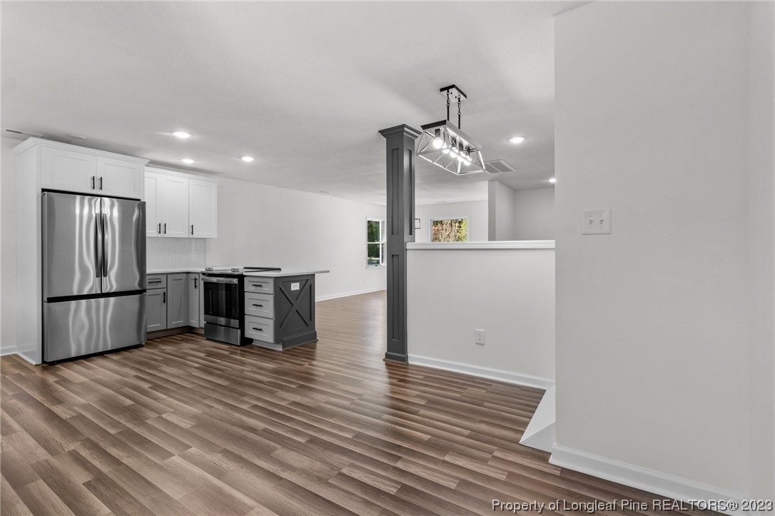 4659 Tabor Church Road Fayetteville, NC 28312 - Photo 10 of 50 a kitchen with stainless steel appliances a refrigerator and wooden floor