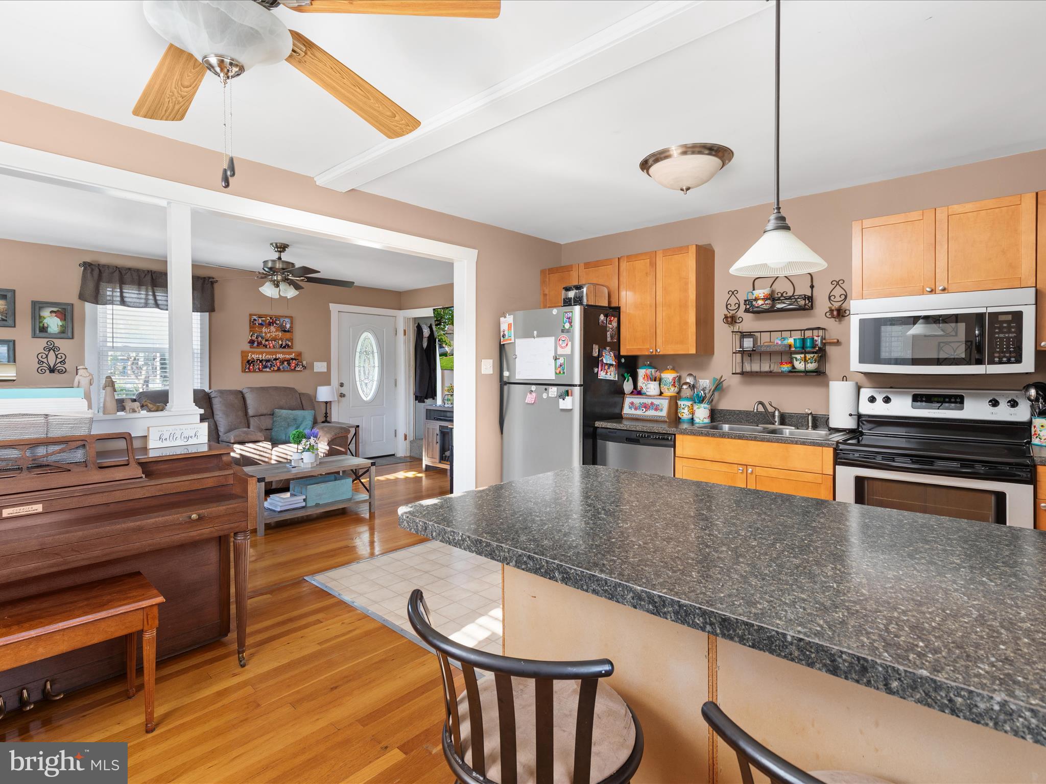 702 Braxton Road Front Royal, VA 22630 - Photo 11 of 61 a kitchen with stainless steel appliances granite countertop a stove top oven a sink a dining table and chairs with wooden floor