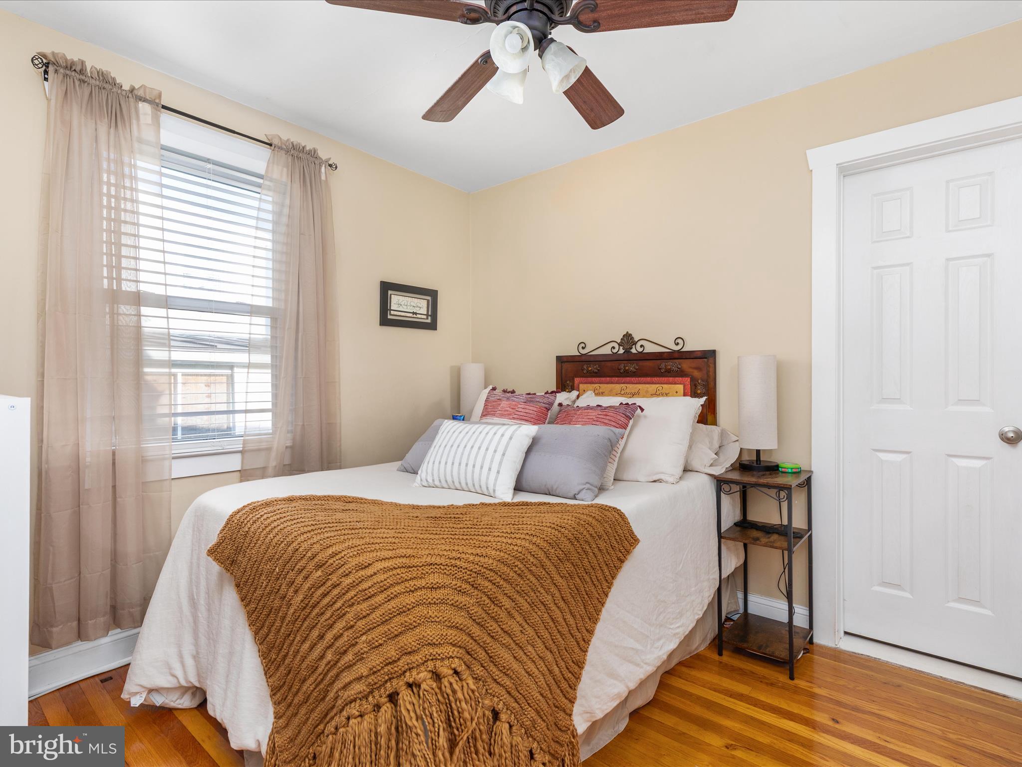 702 Braxton Road Front Royal, VA 22630 - Photo 18 of 61 a bed sitting in a bedroom next to a window and a chandelier