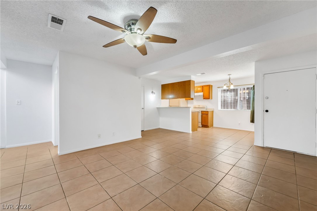 2186 East Desert Inn Road, Unit 2186 Las Vegas, NV 89169 - Photo 5 of 31 Back of Front Door, Dining Area and Kitchen in Back. From Living Room
