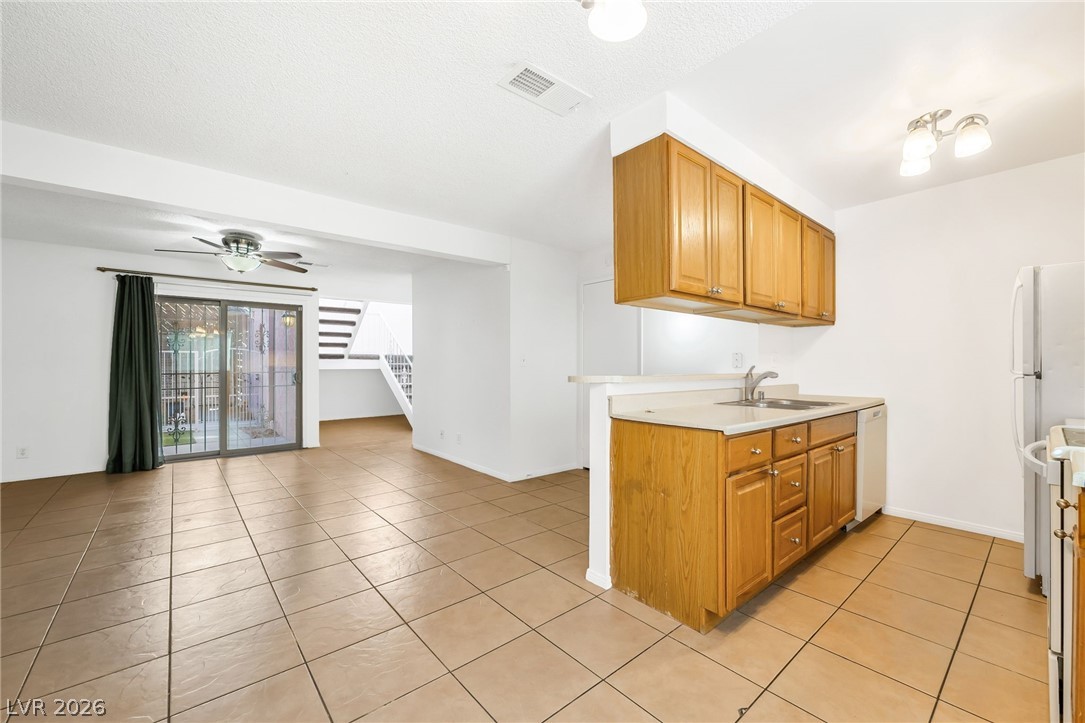 2186 East Desert Inn Road, Unit 2186 Las Vegas, NV 89169 - Photo 8 of 31 View of Back Patio, Living Room and Stairs, and Kitchen from Dining Area
