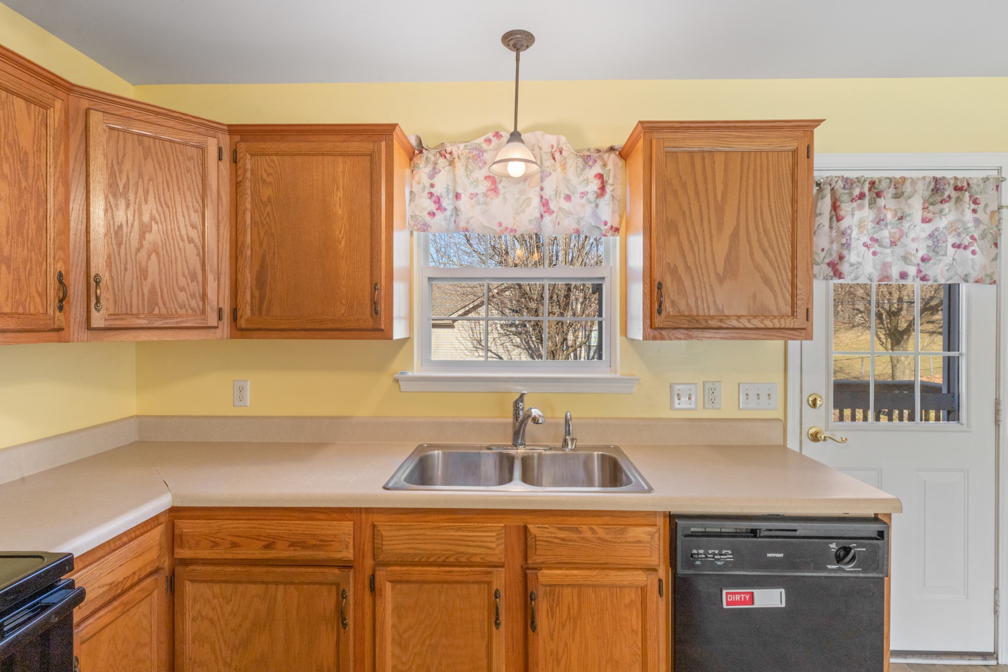 101 Garden View Court Dickson, TN 37055 - Photo 23 of 33 a kitchen with stainless steel appliances granite countertop a sink dishwasher a stove and a refrigerator with wooden cabinets